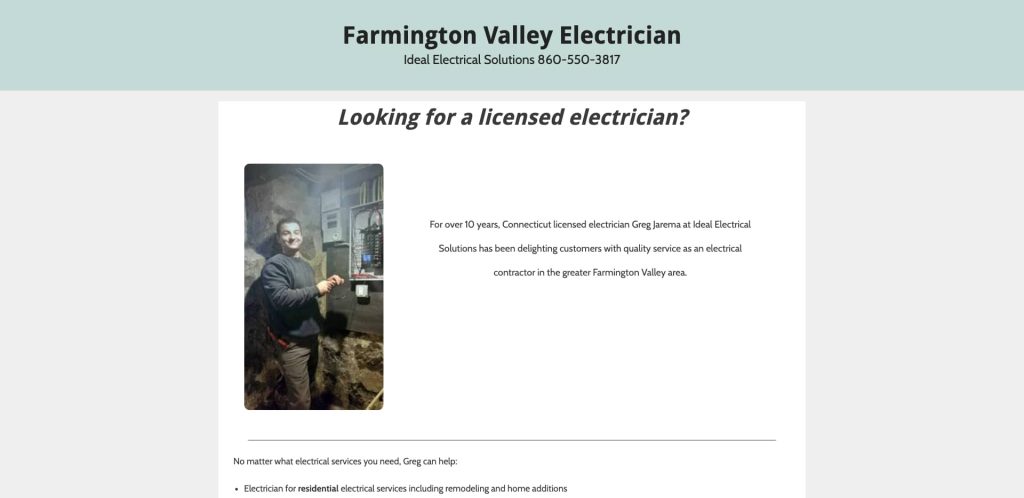 A man wearing a gray hoodie holds electrical tools and smiles at the camera while working on an electrical panel in a basement. The webpage promotes Farmington Valley Electrician services.