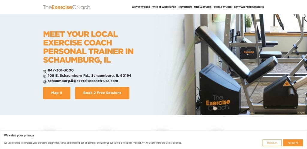 Website banner for The Exercise Coach in Schaumburg, IL, showing gym equipment, contact information, address, and options to map the location or book two free sessions.