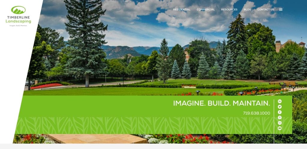 A landscaped park with green grass, colorful flower beds, tall pine trees, and mountains in the background. A green banner with the text “IMAGINE. BUILD. MAINTAIN.” and a phone number appears over the image.