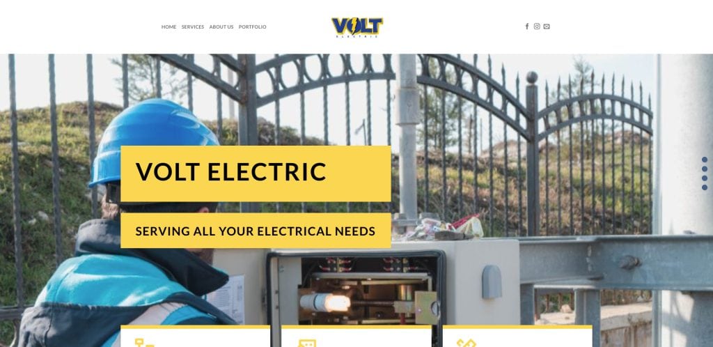 A worker in a blue helmet repairs an outdoor electrical panel near a metal fence. Yellow text boxes read VOLT ELECTRIC and SERVING ALL YOUR ELECTRICAL NEEDS. The Volt Electric website menu is visible at the top.