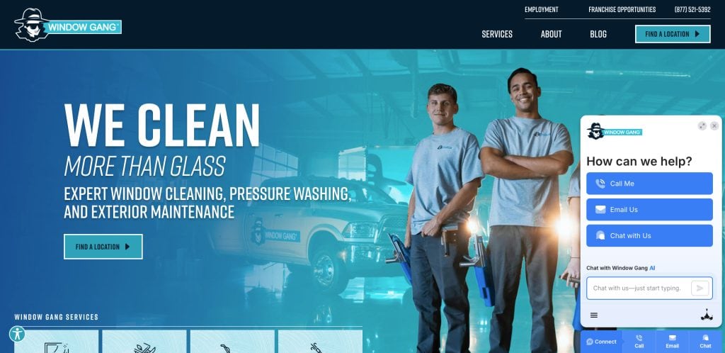 Two uniformed workers stand smiling with arms crossed in front of company vans. Text reads: “WE CLEAN MORE THAN GLASS. Expert window cleaning, pressure washing, and exterior maintenance.” A chat box appears on the right.