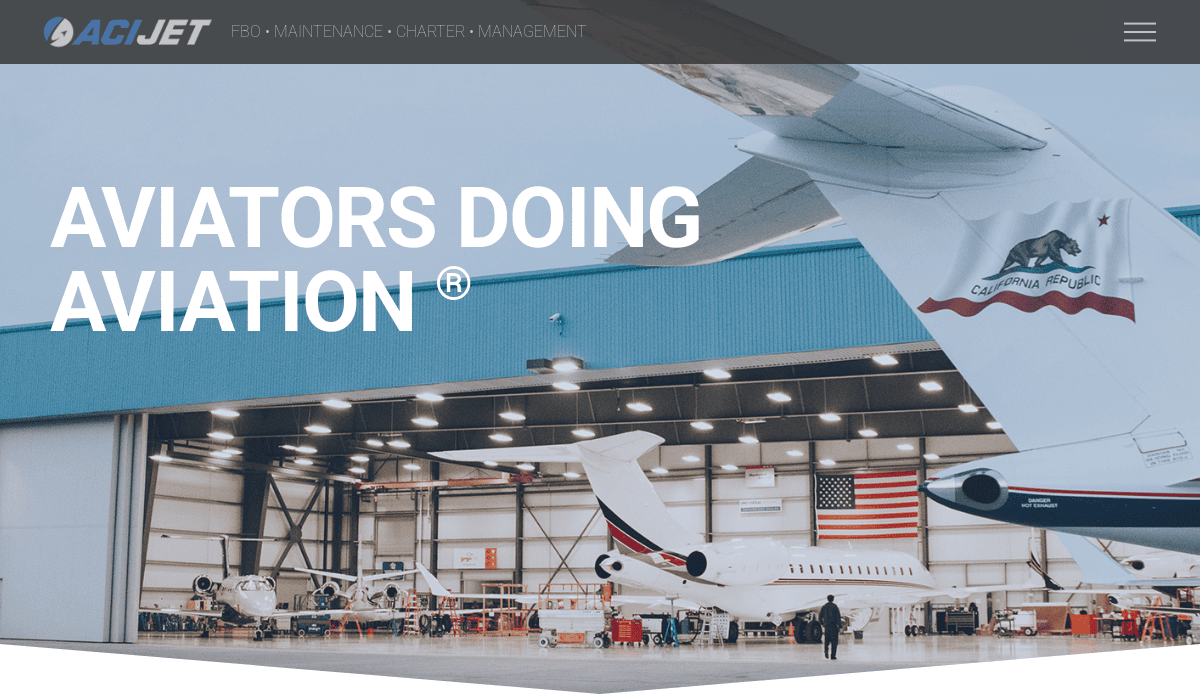Large hangar with open doors reveals two private jets inside, people walking nearby. The California state flag is visible on a jet’s tail. “AVIATORS DOING AVIATION®” text and ACJ Jet logo shine—perfect inspiration for aviation website design or your digital hangar.