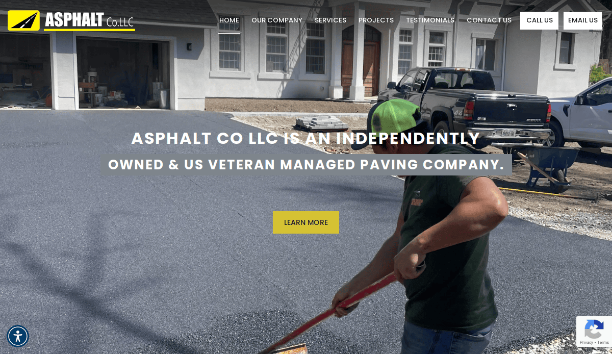 A worker in a green cap spreads fresh asphalt with a tool in front of a white house, while a black pickup truck is parked nearby. The website header highlights that Asphalt Co LLC is an asphalt contractor that drives results and is veteran-managed.