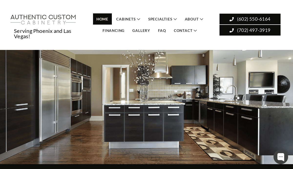 Modern kitchen with dark wood cabinets crafted by expert cabinet makers, stainless steel appliances, a large island with a decorative centerpiece, and an area rug. The website header features stylish website design, navigation links, and two phone numbers for contact.