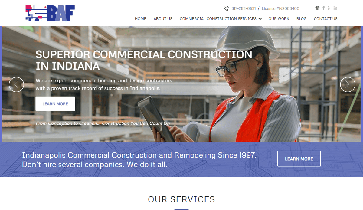 A professional woman in safety gear and a hard hat uses a tablet on a commercial construction site. The website header highlights BAF’s commercial construction expertise in Indiana, and showcases modern website design reflecting experience since 1997.