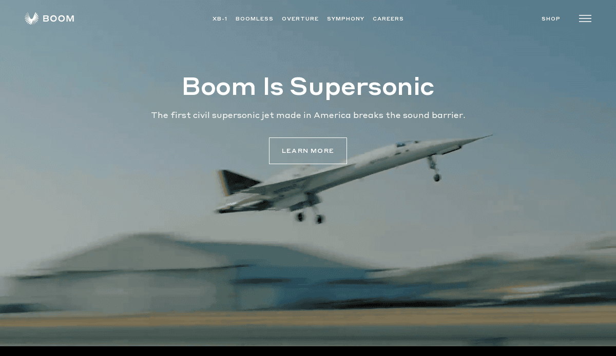 A sleek supersonic jet takes off against a blurred background, showcasing Boom Is Supersonic and a prominent Learn More button—perfect inspiration for future-proofing your aviation website design.