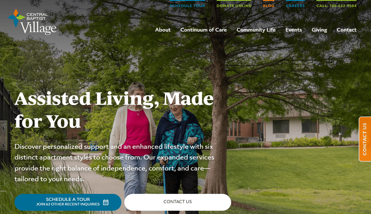 Two older women walk together on a paved path by trees, smiling and talking. The site features inviting assisted living website design, helping Central Baptist Village open its digital front door to families seeking caring senior services.