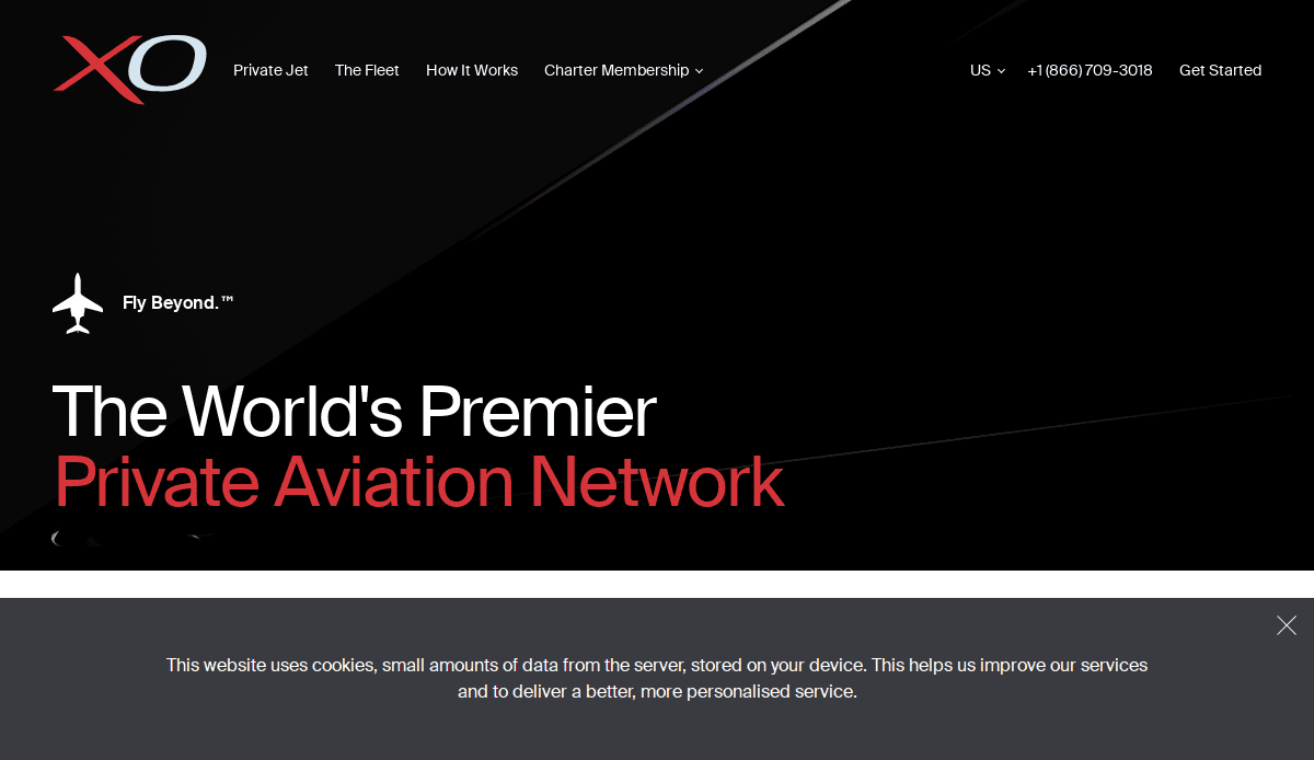 Screenshot of XO’s aviation website design homepage with logo, navigation links, contact number, and text reading “The Worlds Premier Private Aviation Network” above a cookie consent banner, showcasing a digital hangar experience.