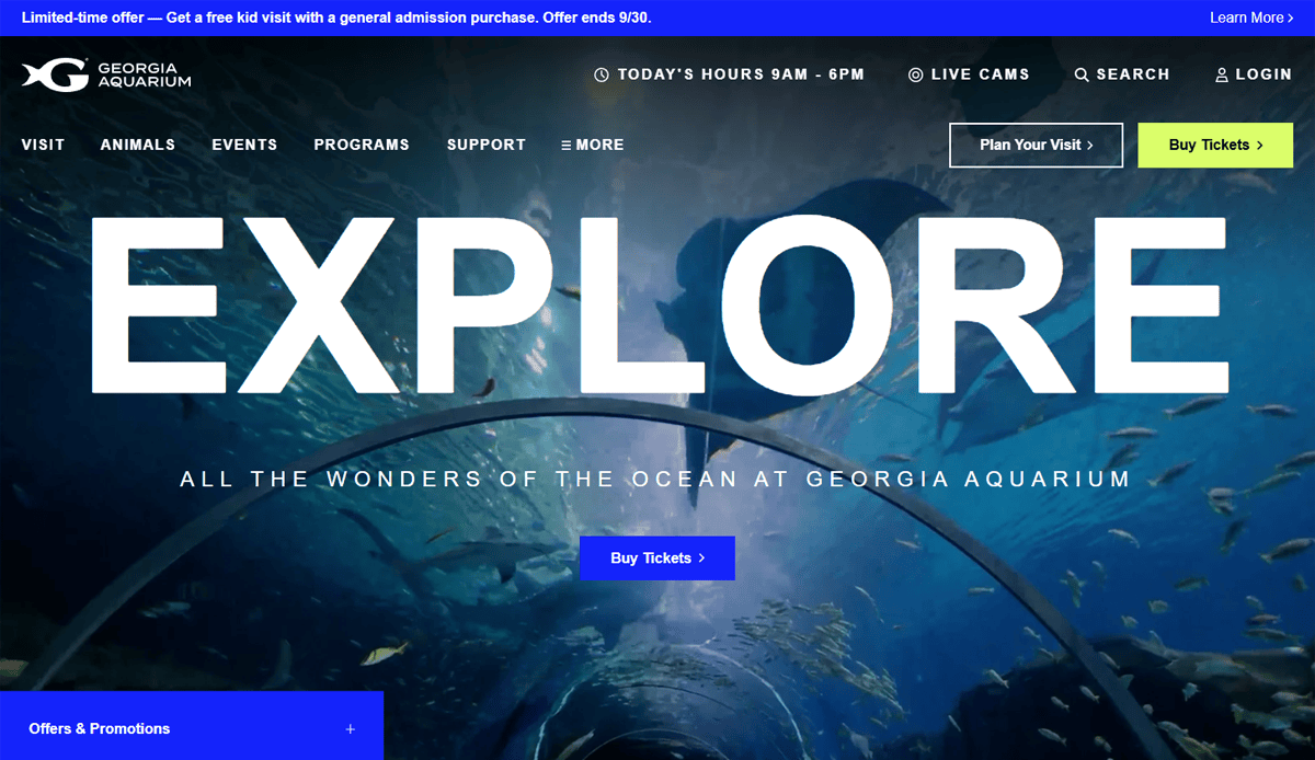 Website homepage for Georgia Aquarium features stunning aquarium website design, showcasing a view from an underwater tunnel with fish swimming above. Large EXPLORE text, easy navigation menus, visit planning, and ticket purchase buttons help with converting traffic.