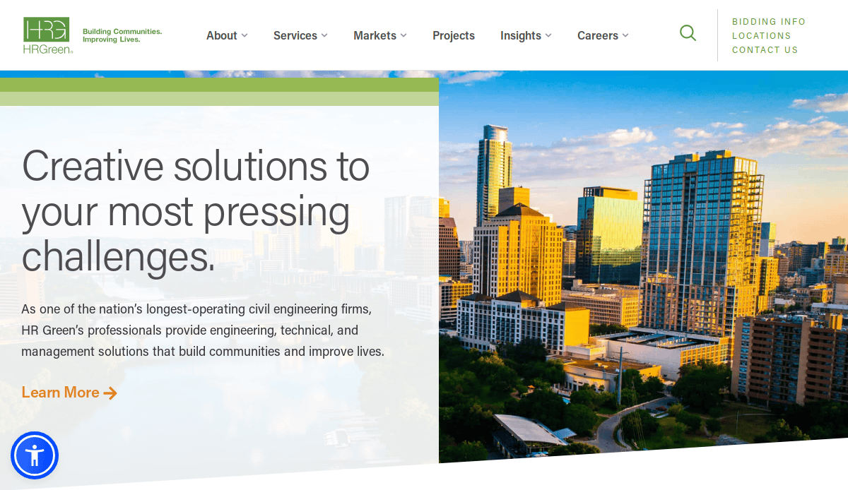 Website homepage with a city skyline at sunset in the background; text reads “Creative solutions to your most pressing challenges” for HR Green, a leader in civil engineering. Menu options are visible at the top, showcasing smart website design.