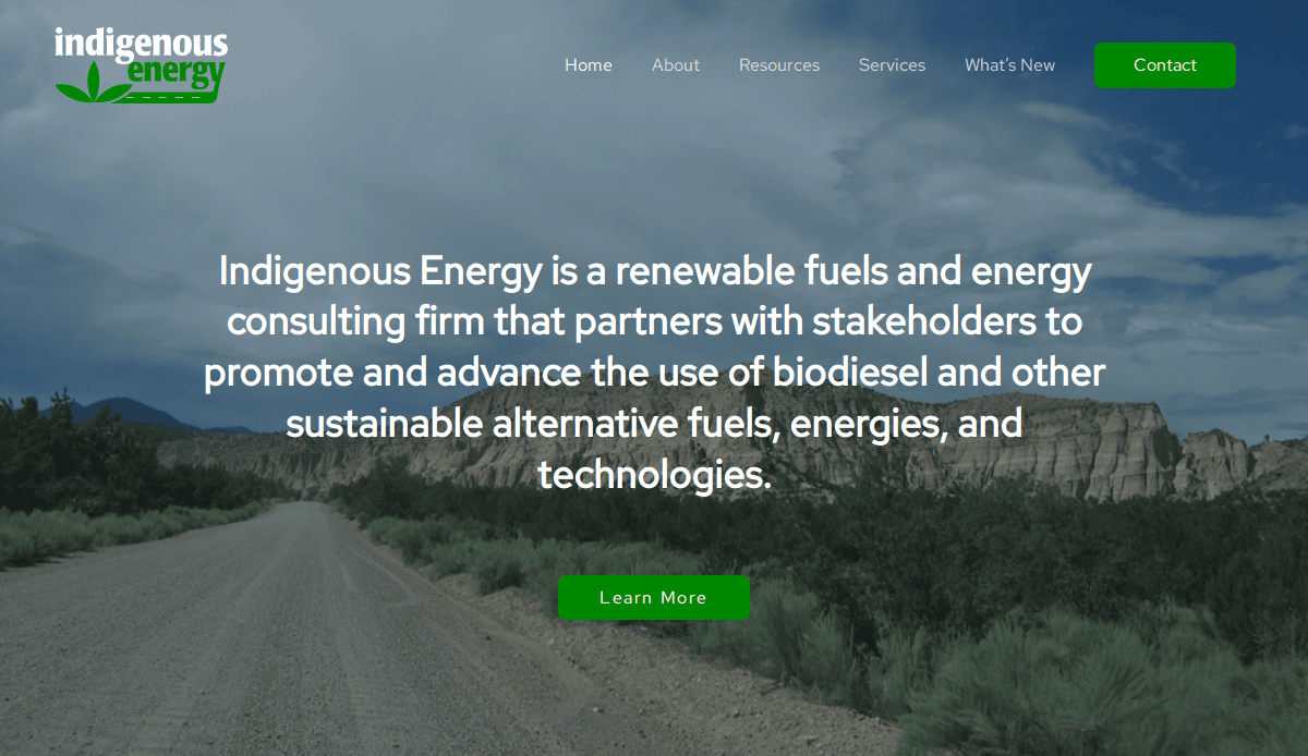 Website homepage for Indigenous Energy with a landscape, dirt road, green “Learn More” button, menu options, and a mission statement about advancing biodiesel. A consultant website design to win clients and showcase alternative energy technologies.