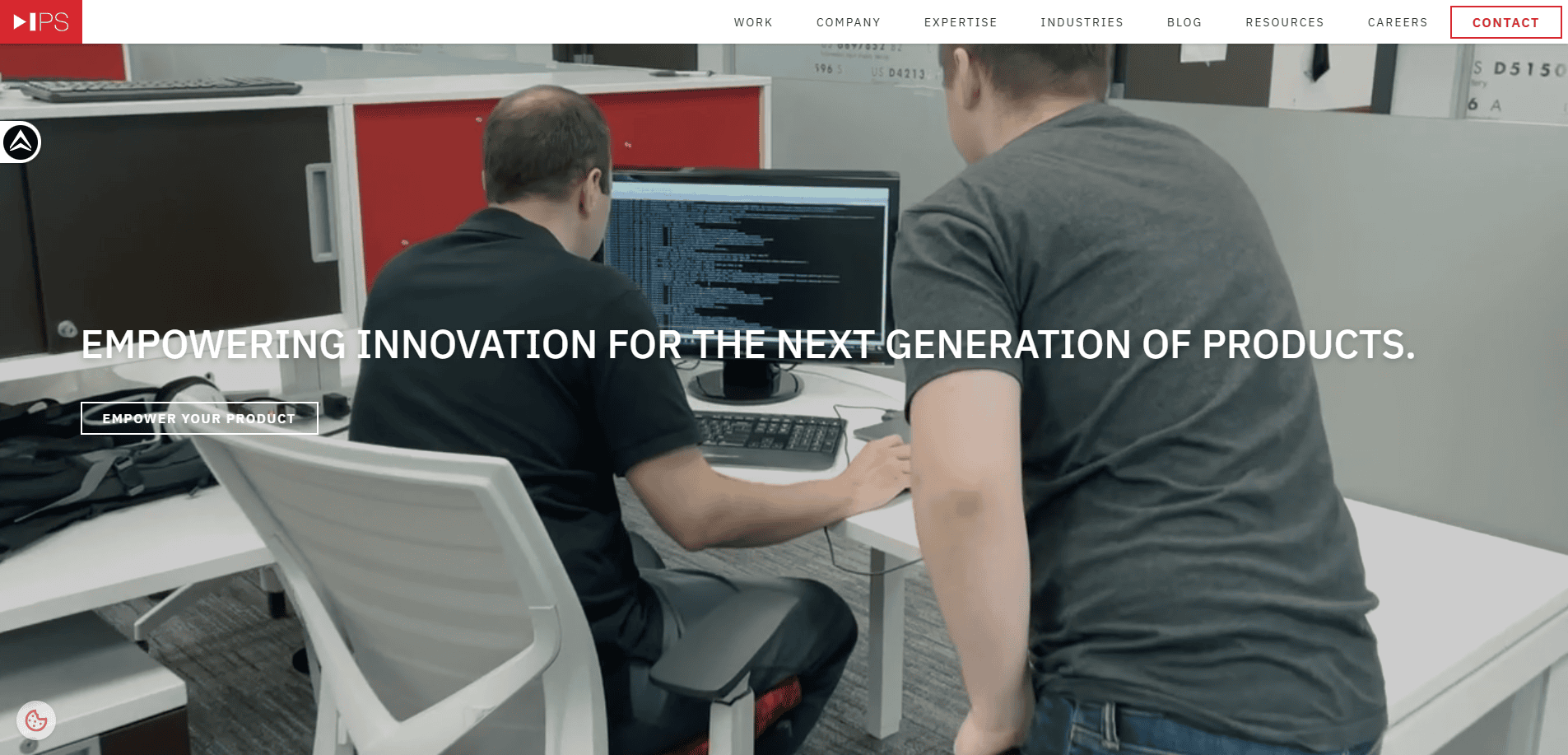 Two people work together at a computer station displaying code. The modern office features white desks and red accents. Text on the image reads, Empowering innovation in Website Design for the next generation of products.