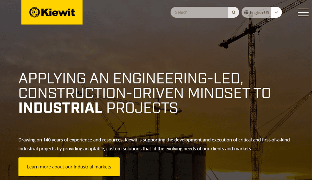 A professional website design for Kiewit features a yellow and black logo, navigation menu, and a background of cranes at a commercial construction site, highlighting their engineering-led, construction-driven approach to industrial projects.