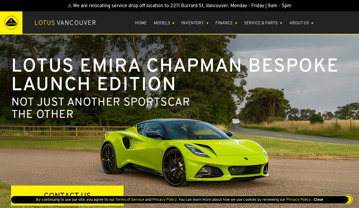 A bright yellow Lotus Emira sports car is parked on grass near trees under a cloudy sky. The automotive website design for Lotus Vancouver features menus and a banner announcing the Emira Chapman Bespoke Launch Edition.