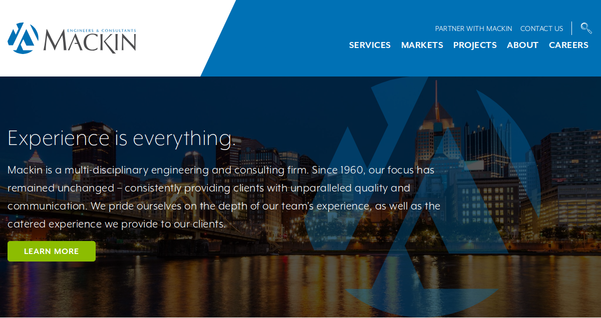 Homepage of Mackin civil engineering and consulting firm, featuring their logo, tagline Experience is everything, a city skyline at dusk, and navigation links for services, markets, projects, about, and careers—showcasing modern engineering website design.