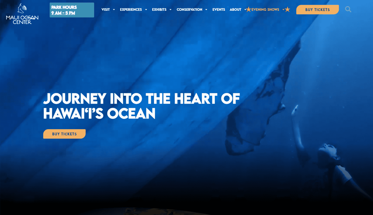 Website homepage for Maui Ocean Center features an aquarium website design with a deep blue underwater background, a diver, and white text reading Journey into the Heart of Hawaii's Ocean. A yellow Buy Tickets button encourages visitors to convert traffic.
