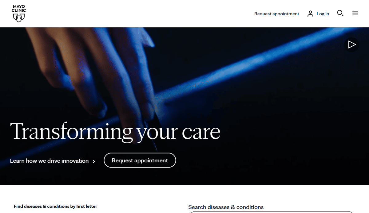 A close-up of a hand illuminated by blue light appears above the words Transforming your care on this health & wellness website, with options to learn about innovation or request an appointment.