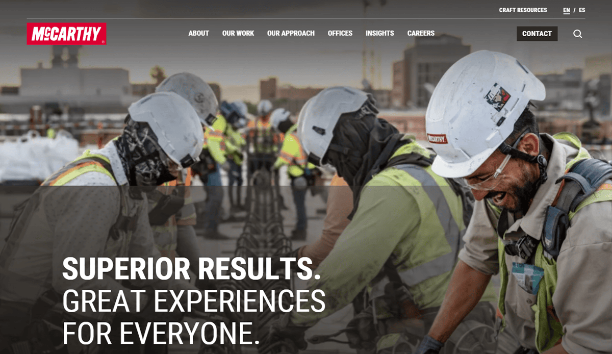 Construction workers in safety gear collaborate on a building site with city buildings behind. The overlay text reads “SUPERIOR RESULTS. GREAT EXPERIENCES FOR EVERYONE.” Perfect for a professional construction website. The McCarthy logo is at the top left.