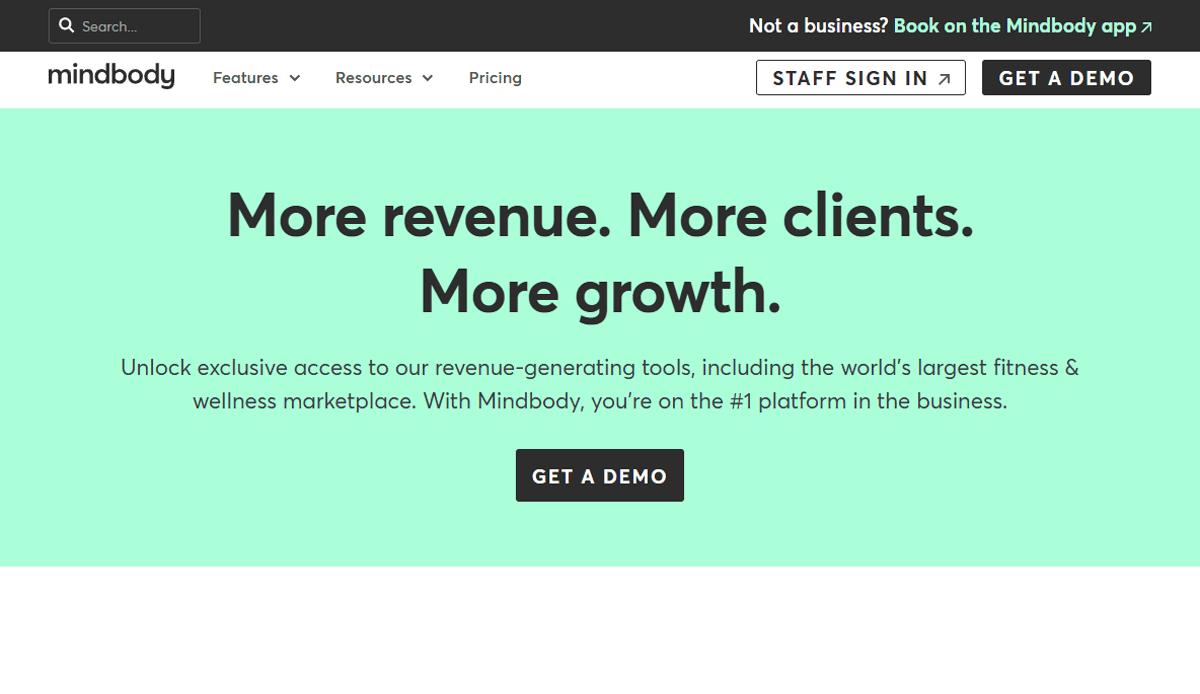 Screenshot of the Mindbody health & wellness website homepage featuring the text: More revenue. More clients. More growth. with a button labeled Get a demo and navigation links at the top.