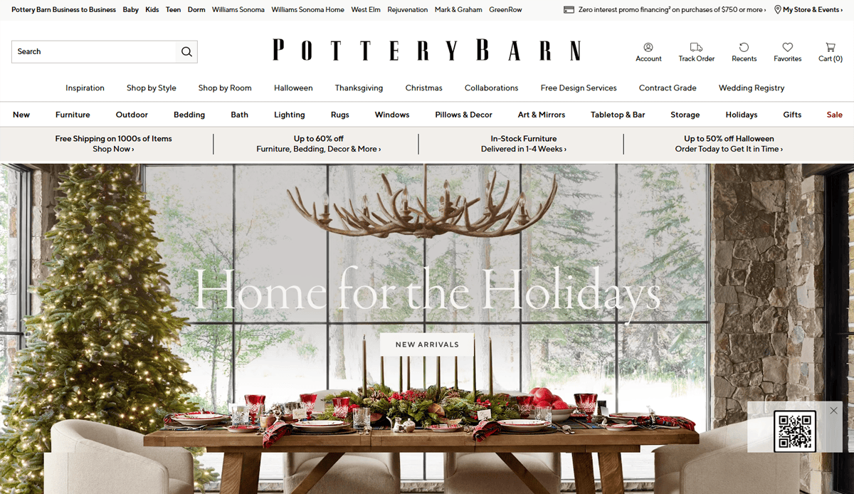 A festive dining room with a decorated Christmas tree, antler chandelier, stylish holiday table setting, and large windows with snowy scenery showcases elegant furniture website design. The Pottery Barn website banner displays holiday promotions and navigation links.