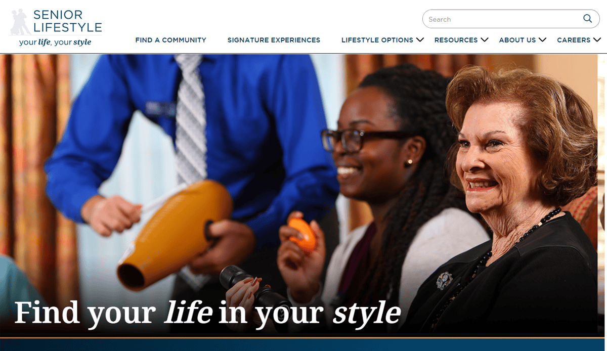 A smiling older woman and a younger woman play percussion instruments with others in a lively group setting. The text reads: Find your life in your style, on our Assisted Living Website.