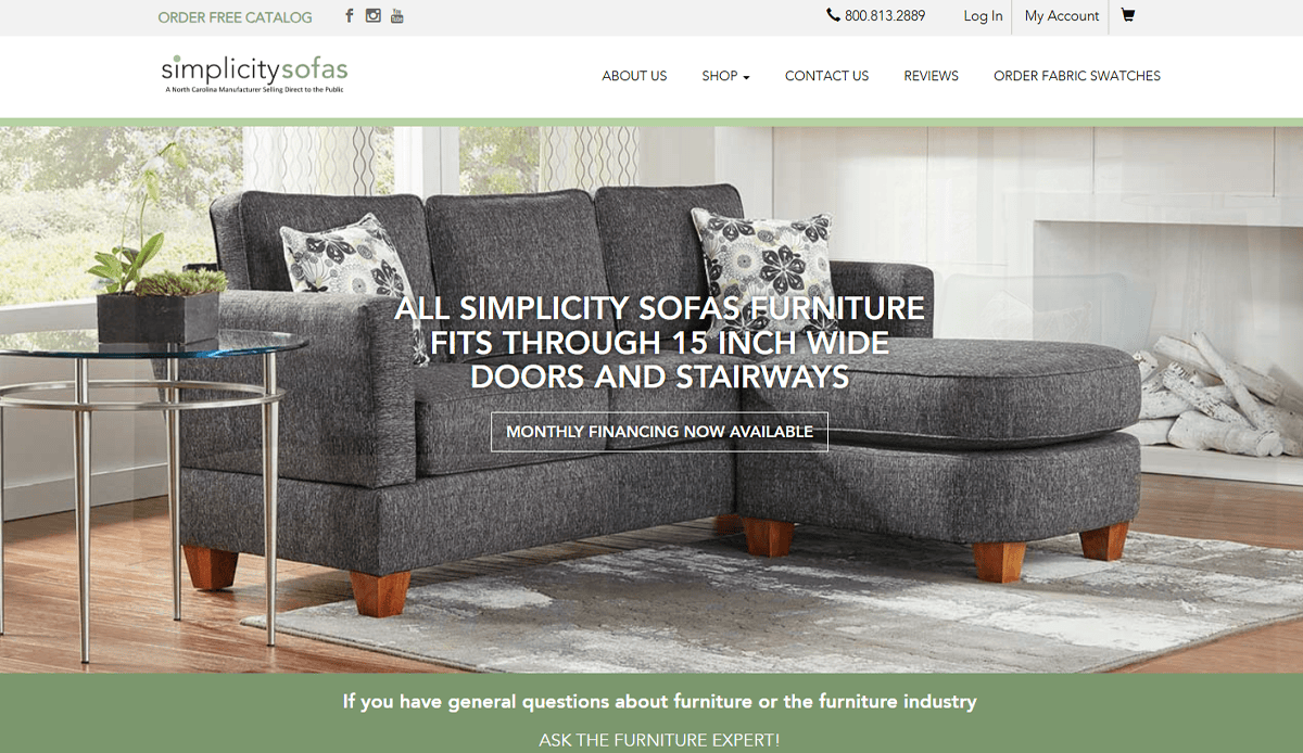 A modern gray sectional sofa with patterned pillows is showcased in a living room setting, highlighting stylish furniture website design. The space features a large window, green plant, wooden coffee table, and visible website header and navigation.