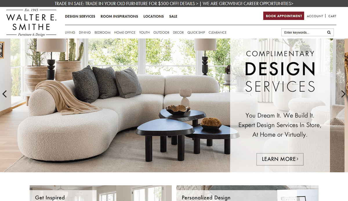 A modern living room with a large cream-colored sectional sofa, black coffee tables, and large windows letting in natural light. Text reads: Complimentary Design Services for your Furniture Website Design. You dream it. We build it.