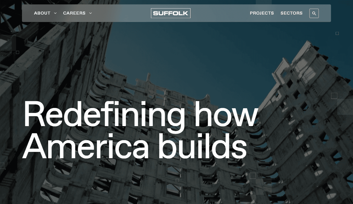 View of a tall, unfinished concrete building against a blue sky with the words Redefining how America builds overlayed; Suffolk’s website design and professional menu appear at the top.