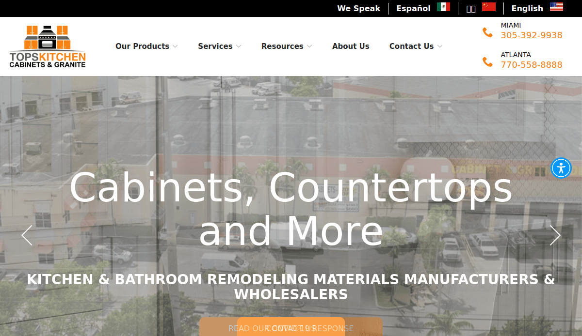 Screenshot of Tops Kitchen Cabinets & Granite website homepage, featuring company logo, contact numbers for Miami and Atlanta, navigation menu, and a banner text “Cabinets, Countertops and More” over a cityscape background showcasing expert cabinet makers.