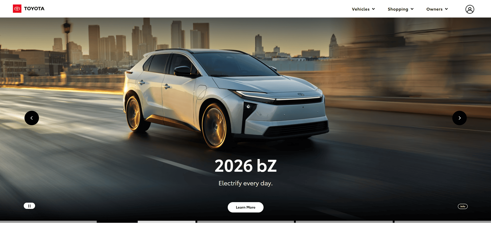A silver Toyota 2026 bZ electric SUV drives on a city road at sunset, blurred buildings behind. Text reads: 2026 bZ. Electrify every day—where automotive website design and innovation meet the road.
