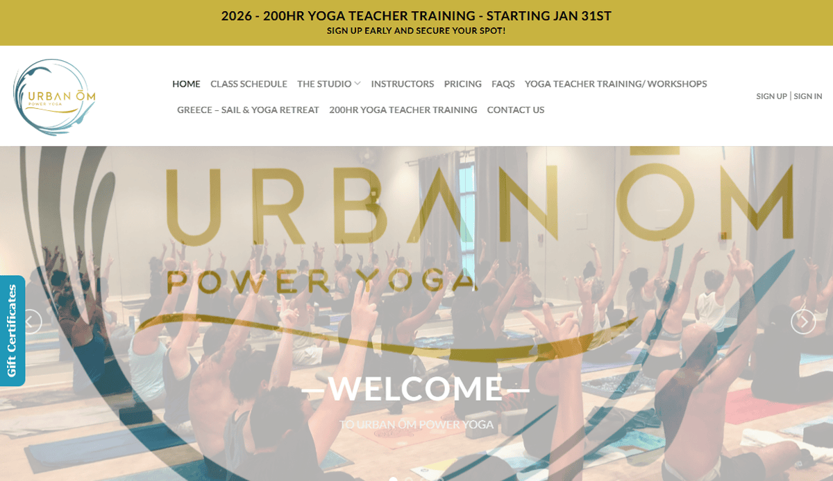 Screenshot of the Urban Om Power Yoga health & wellness website homepage, featuring a group class with participants raising their arms, plus easy navigation for classes, pricing, retreats, and teacher training.