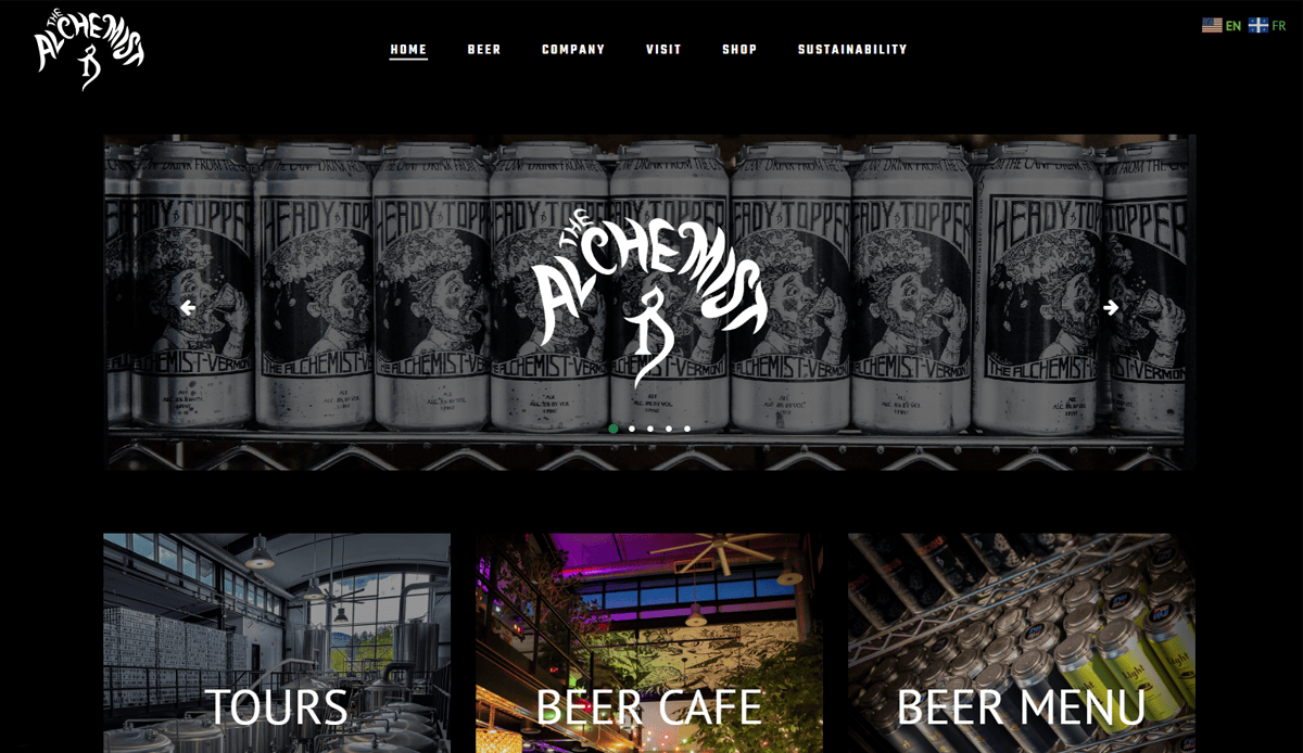 Screenshot of The Alchemist brewery website homepage, showcasing cutting-edge Brewery website design with intricate black-and-white beer can labels, the Alchemist logo, and intuitive menu links for tours, beer cafe, and beer menu—all on a sleek black background.