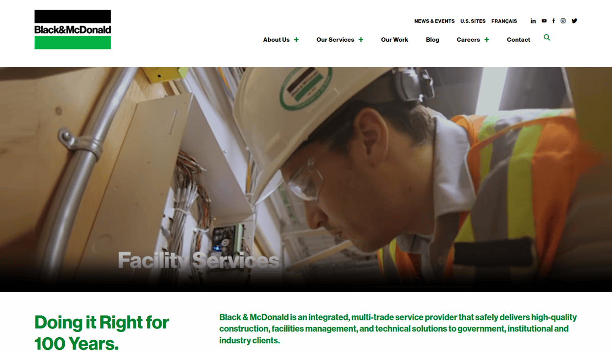 A construction worker wearing a hard hat and safety glasses examines equipment indoors. The Black & McDonald logo tops a website design with site navigation above a headline stating “Doing it Right for 100 Years.”.