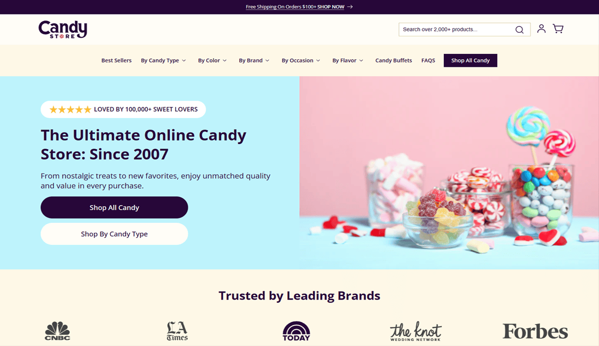 Screenshot of Candy Store’s homepage showcasing a pastel Candy Website Design, jars of colorful candies on the right, and a description on the left promoting “The Ultimate Online Candy Store: Since 2007.” Trusted brand logos are displayed below.