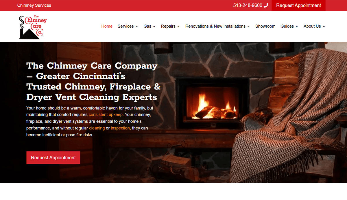 A cozy living room with a stone fireplace, wood mantle, burning fire, and a log stack. A person sits by the fire under a blanket. The website highlights chimney and fireplace services with effective Chimney Repair Website Design for better conversions.
