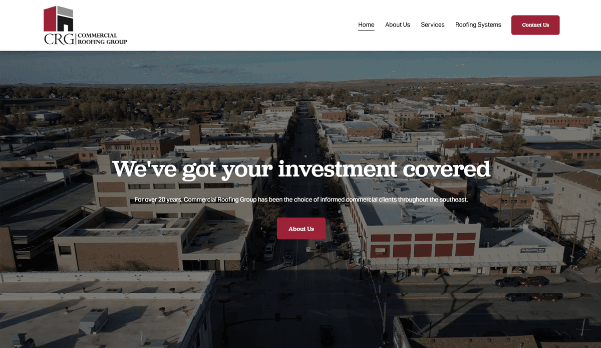 Aerial view of a small city downtown with commercial buildings, overlaid with text promoting Commercial Roofing Group, a navigation bar at the top, and highlighting expert commercial roofing website design for boosting local leads.