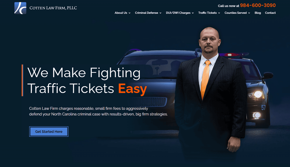 A serious man in a suit stands in front of a police car with flashing lights. The text reads, "We Make Fighting Traffic Tickets Easy,” highlighting Cotten Law Firm’s expertise and effective attorney website design to boost conversions. Button: “Get Started Here.”.