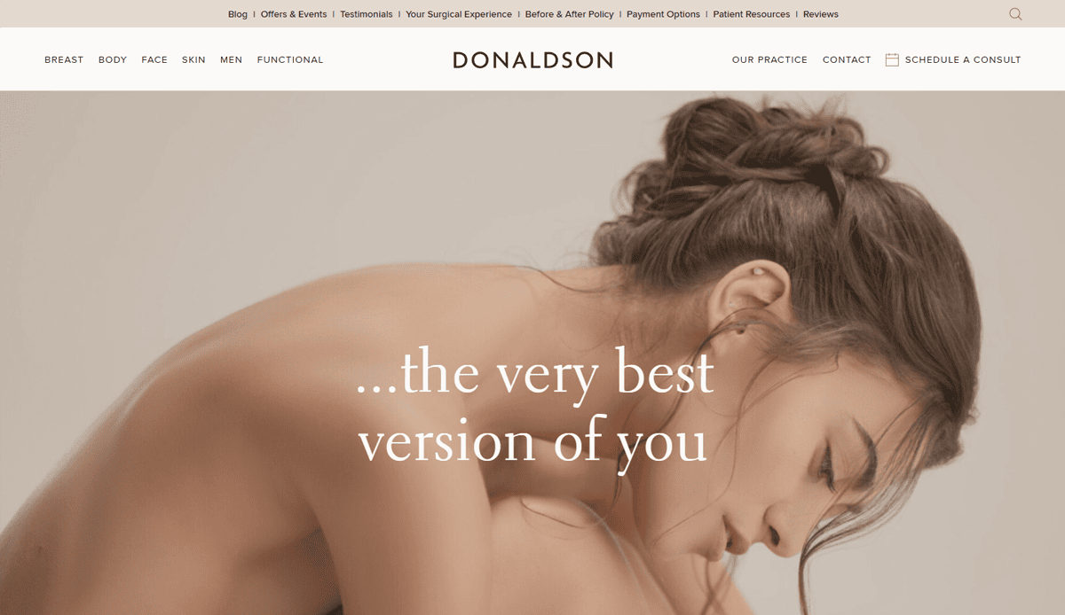 A woman with long brown hair is sitting and looking down with her arm resting on her knee. Soft lighting and neutral tones give the image a calm feel—perfect for a cosmetic surgery website design aimed at helping you become the very best version of you.
