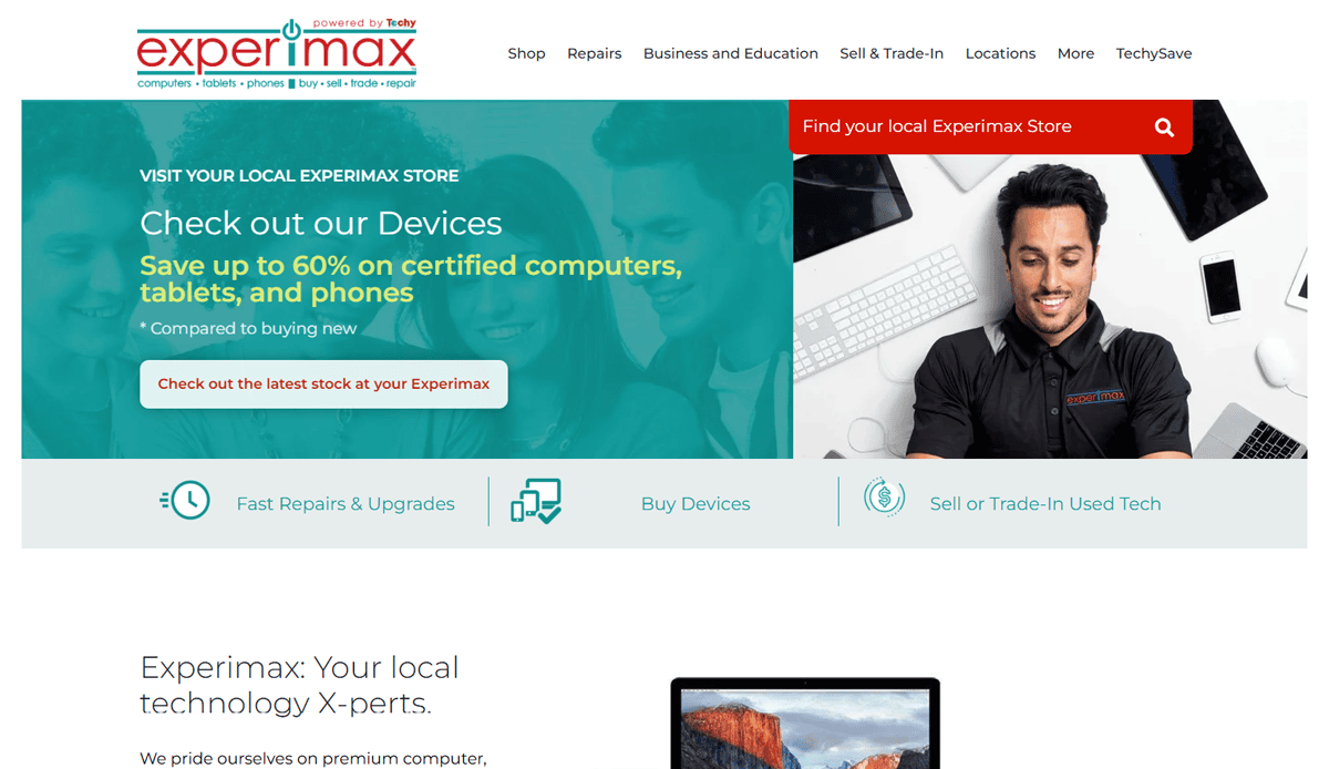 Screenshot of Experimax’s website homepage showing 2025 savings on certified computers, tablets, and phones. A smiling employee assists a customer at a laptop. Navigation menu, search bar, and modern website design are visible at the top.
