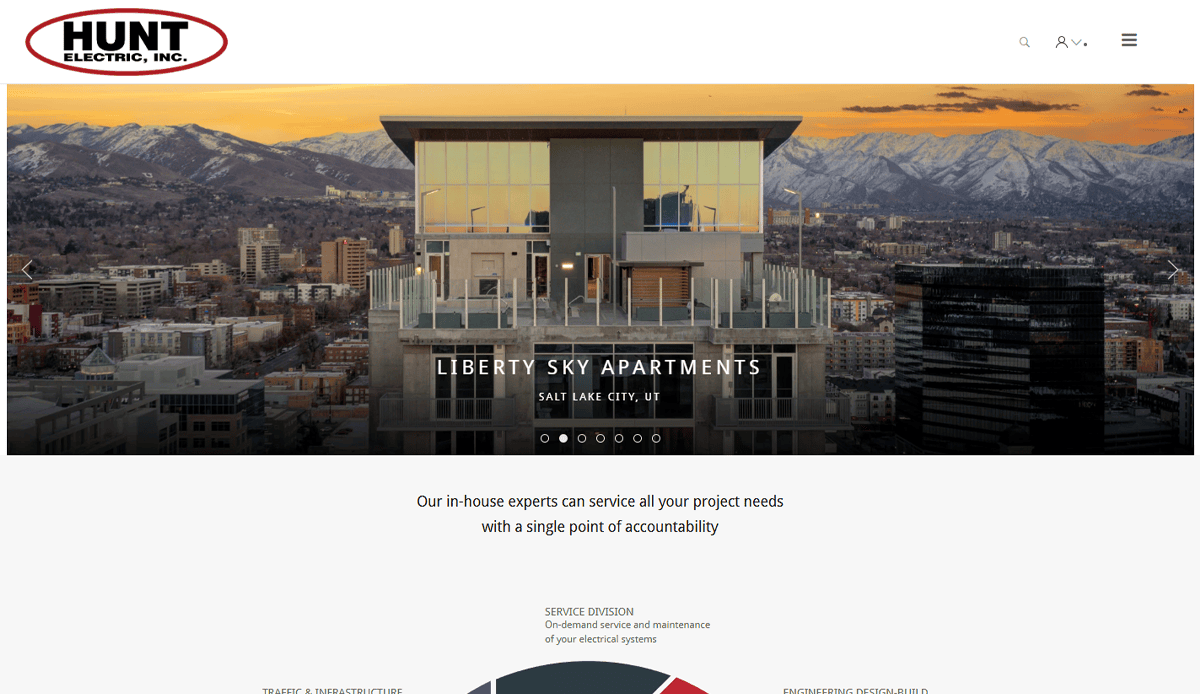 Homepage of Hunt Electric, Inc. featuring a modern apartment building with mountains in the background. The text reads Liberty Sky Apartments, Salt Lake City, UT. Showcasing expert commercial electrician services and a website design that converts.