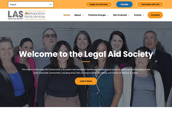 A group of eight professionally dressed people smiling together in front of a gray wall, with the Legal Aid Society website header and navigation bar above them, representing a collaborative effort with family services and social services organizations.