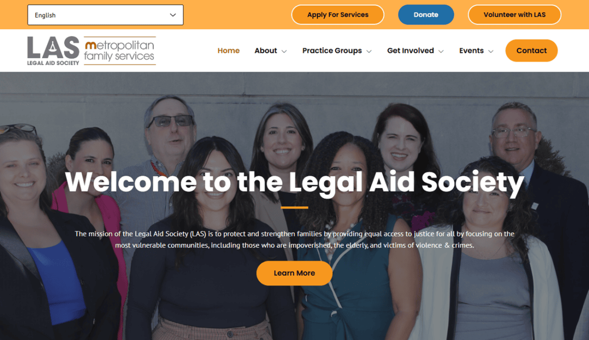 A diverse group of six professionally dressed people smile at the camera. The website highlights services, client reviews, staff, and contact details for Metropolitan Family Services, emphasizing family support and social services.