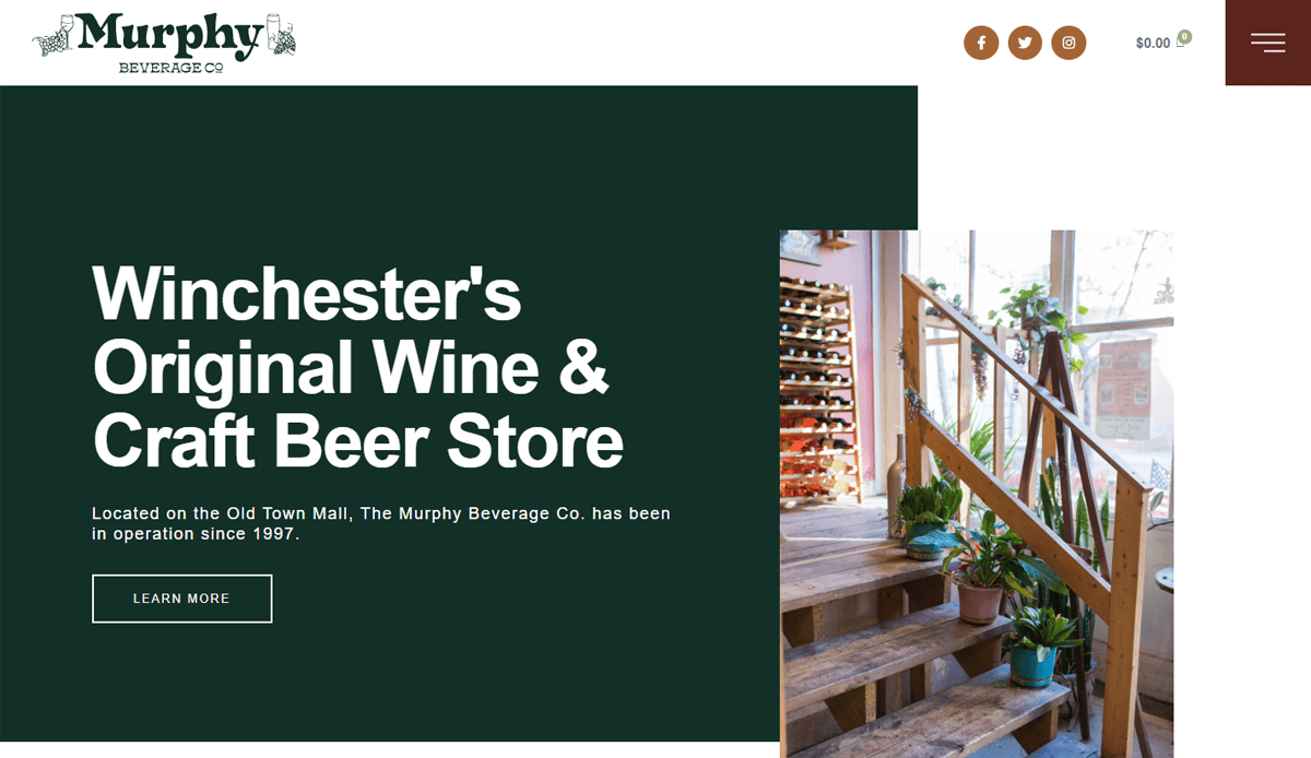 Homepage of Murphy Beverage Co. featuring the text Winchesters Original Wine & Craft Beer Store and a photo of a wooden staircase with potted plants and a wine rack in a well-lit shop interior, showcasing top-notch beverage distributor website design for user engagement.