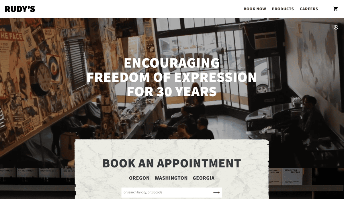 A bustling Barber Shop with customers and stylists, walls covered in posters. Bold text reads, “Encouraging freedom of expression for 30 years.” Below, a booking section powered by a sleek Barber Shop Website for appointments in Oregon, Washington, and Georgia.