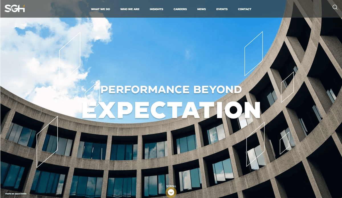 Curved modern office building with large windows against a blue sky, featuring the text “Performance Beyond Expectation” in bold white letters at the center, highlighting innovative website design that drives local leads.