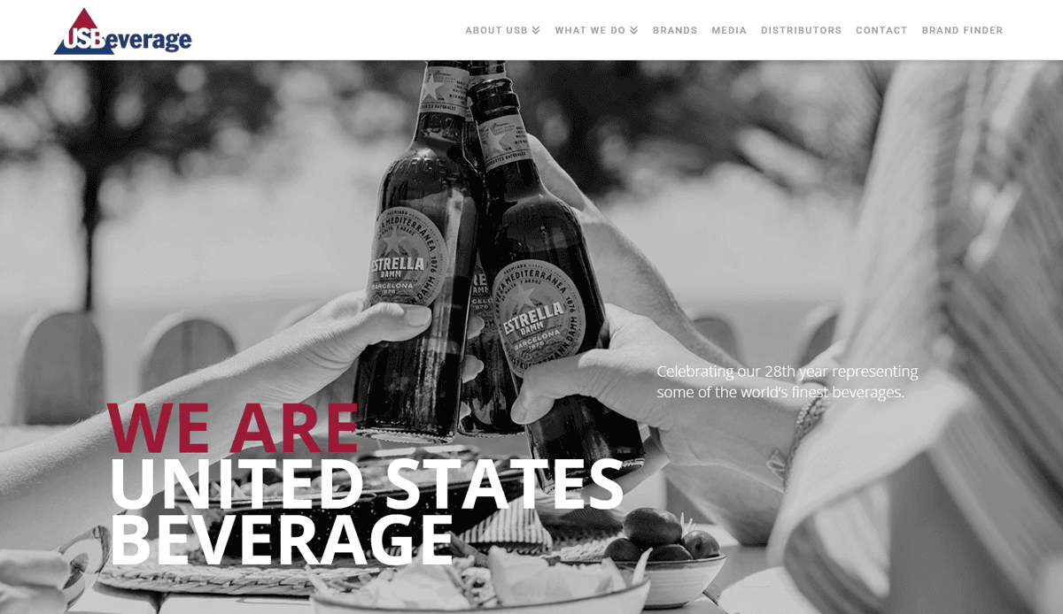 Three people clinking Estrella Jalisco beer bottles at an outdoor table, with WE ARE UNITED STATES BEVERAGE and company information overlaid in white and red text—ideal imagery for a beverage distributor website design focused on user engagement.