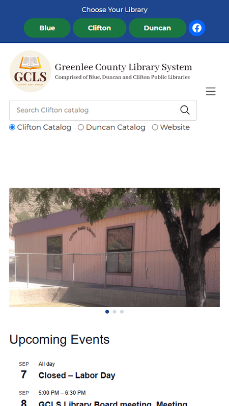 Greenlee County Library System website page featuring a search bar, event calendar with upcoming holiday closures, contact information, useful links, library location and hours. The page also includes a footer with policies and a photo of the Greenlee County Library building.