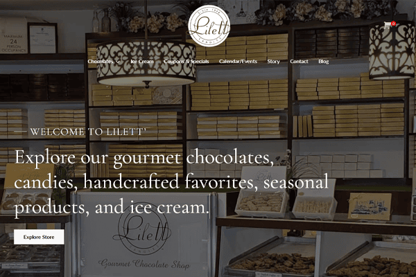 Bakery display filled with chocolate boxes and trays of treats; flowers and decorative items on shelves. Text reads: Welcome to Lilett, home of Lilett Candies—explore our gourmet chocolates, candies, handcrafted favorites, and ice cream.