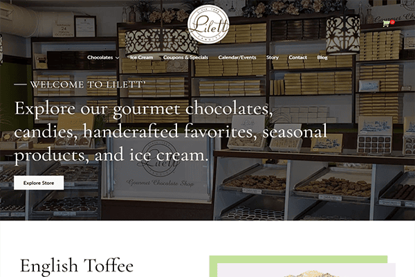 Website homepage for Lilett Gourmet Chocolate Shop featuring shelves of chocolate boxes, bins of candy, and text inviting visitors to explore chocolates, candies, seasonal products, and ice cream.