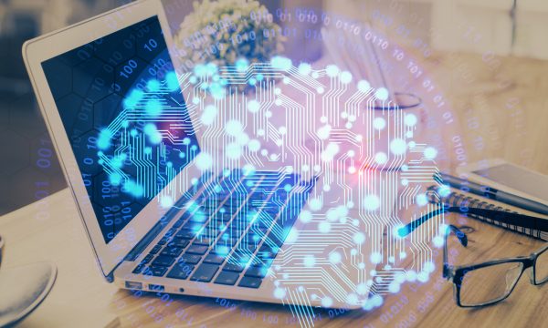 A laptop on a desk with glasses and a cup, overlaid with a glowing digital brain and binary code, symbolizing the innovative intersection of artificial intelligence and technology—perfect for showcasing cutting-edge AI Websites or dynamic WordPress Websites.
